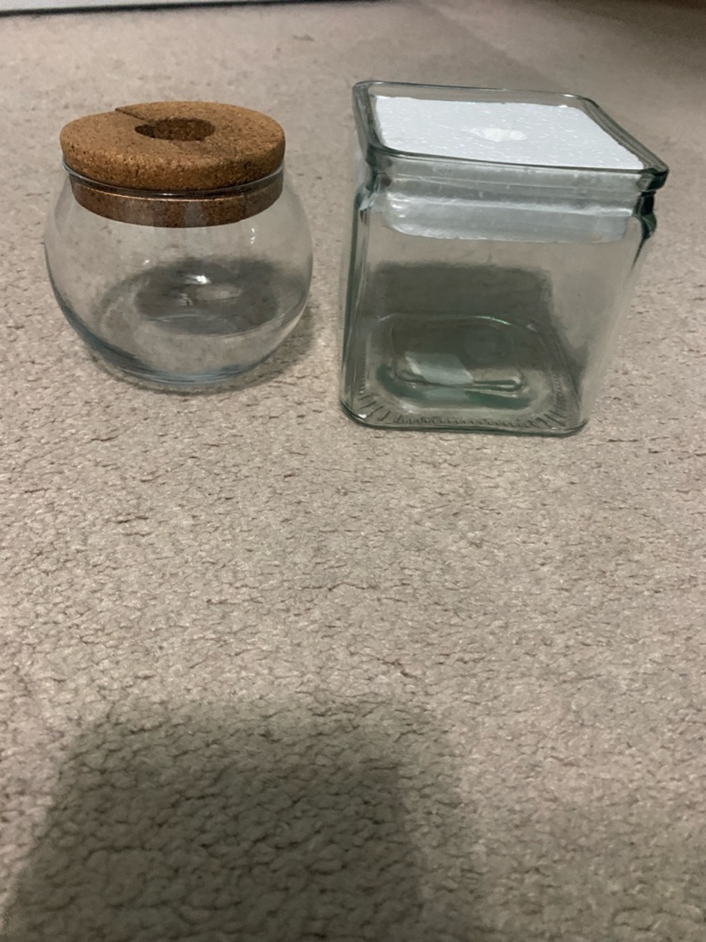 Two Clear Glass Storage Jar and round vase with cork top for a pant to come out.